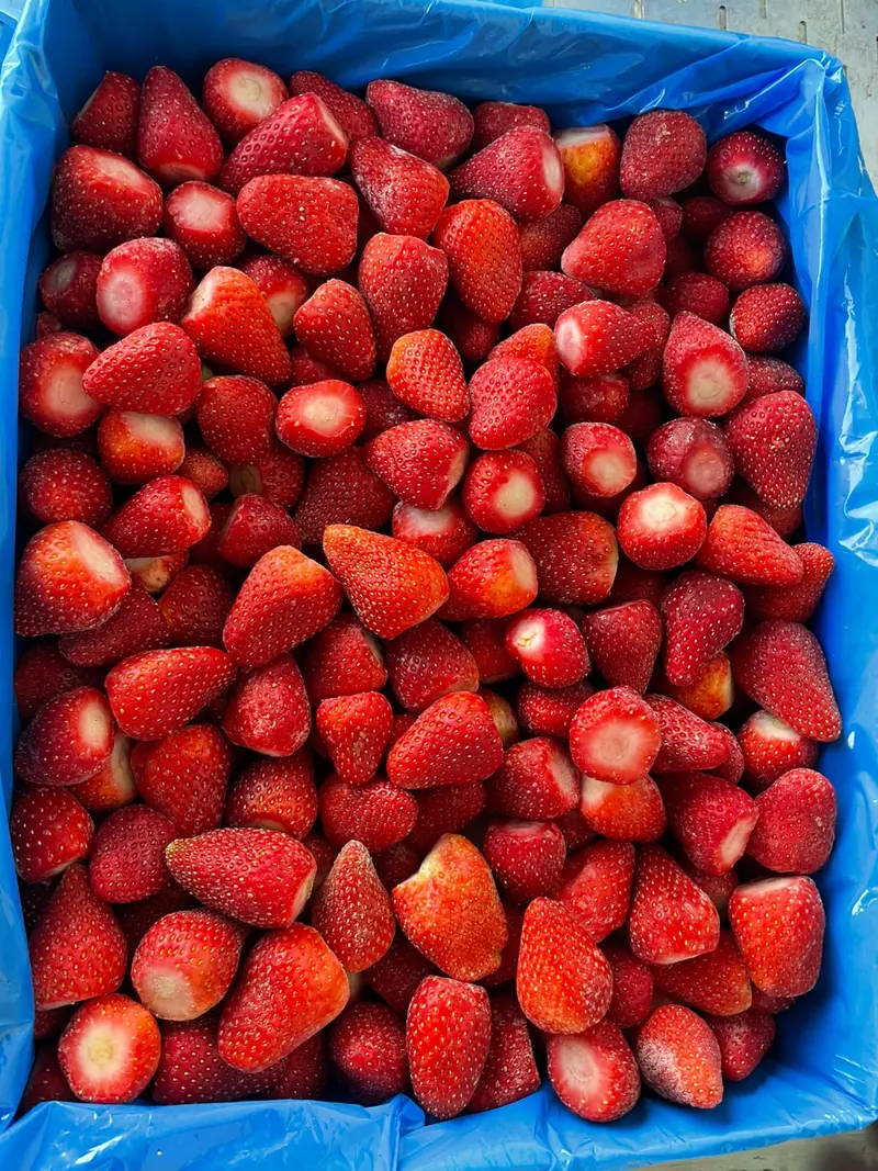 A crate full of freshly picked red strawberries