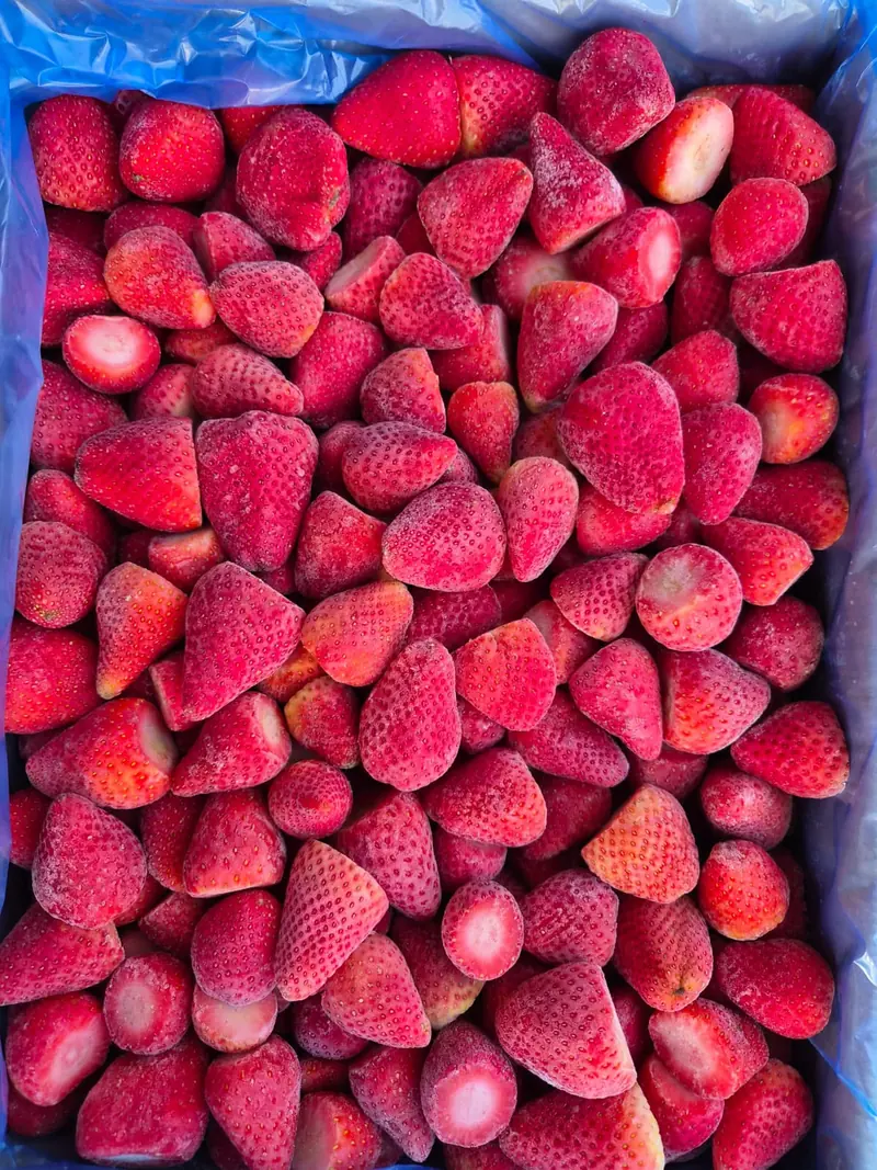A carton of frosted whole IQF strawberries