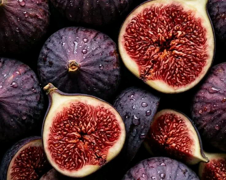 Purple figs, whole and halved to show the red interior